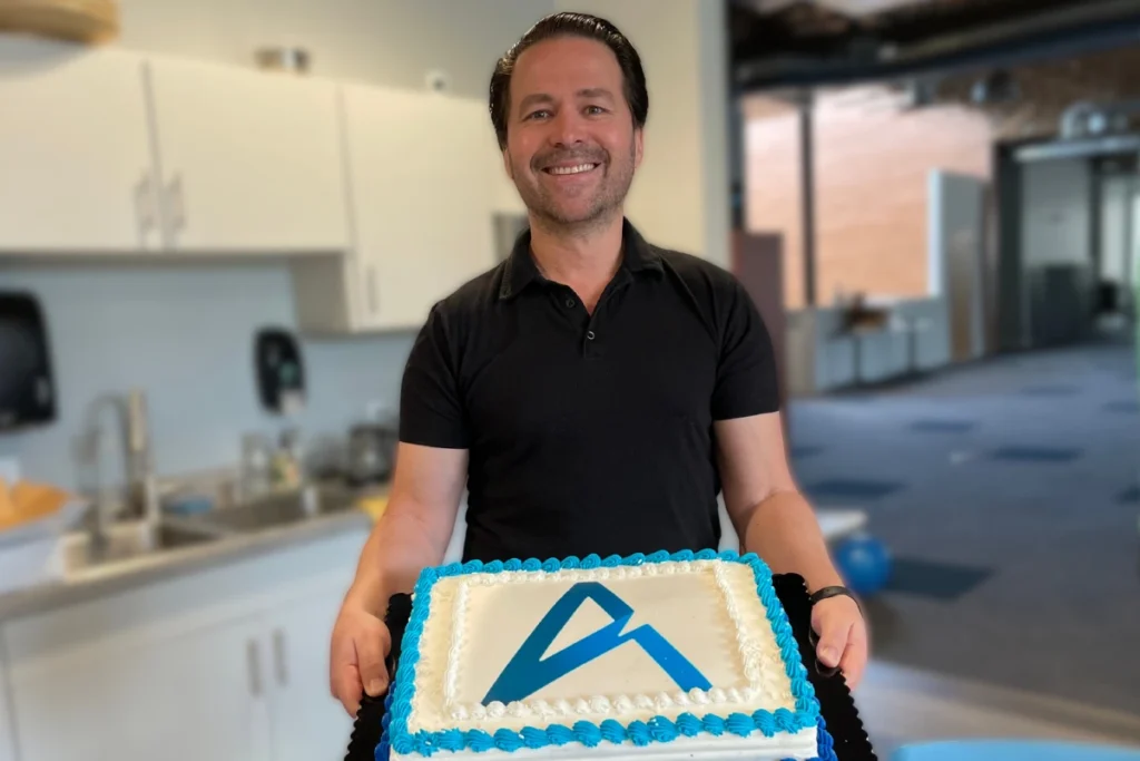 CEO of Altitude, Frantz Widmaier celebrating a successful launch week with a slice of cake.